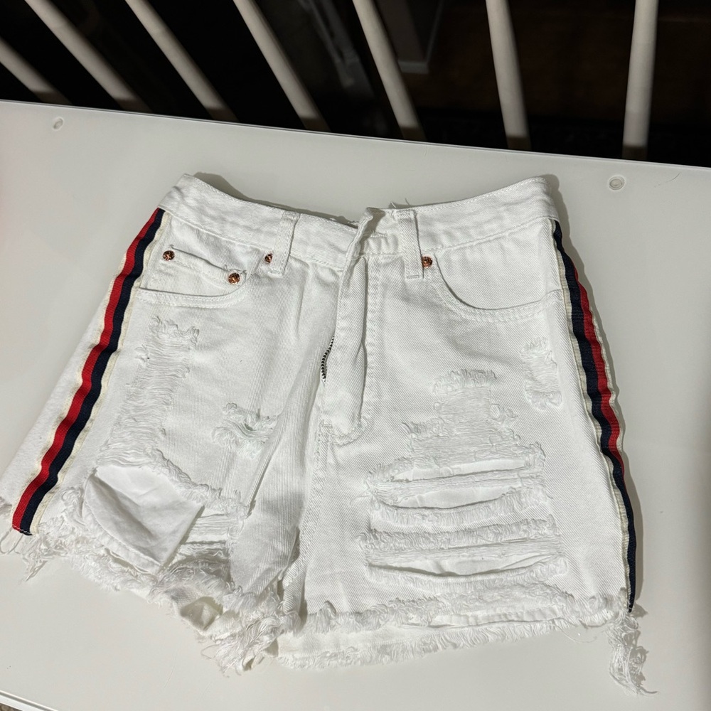 White denim shorts with red and blue stripe
